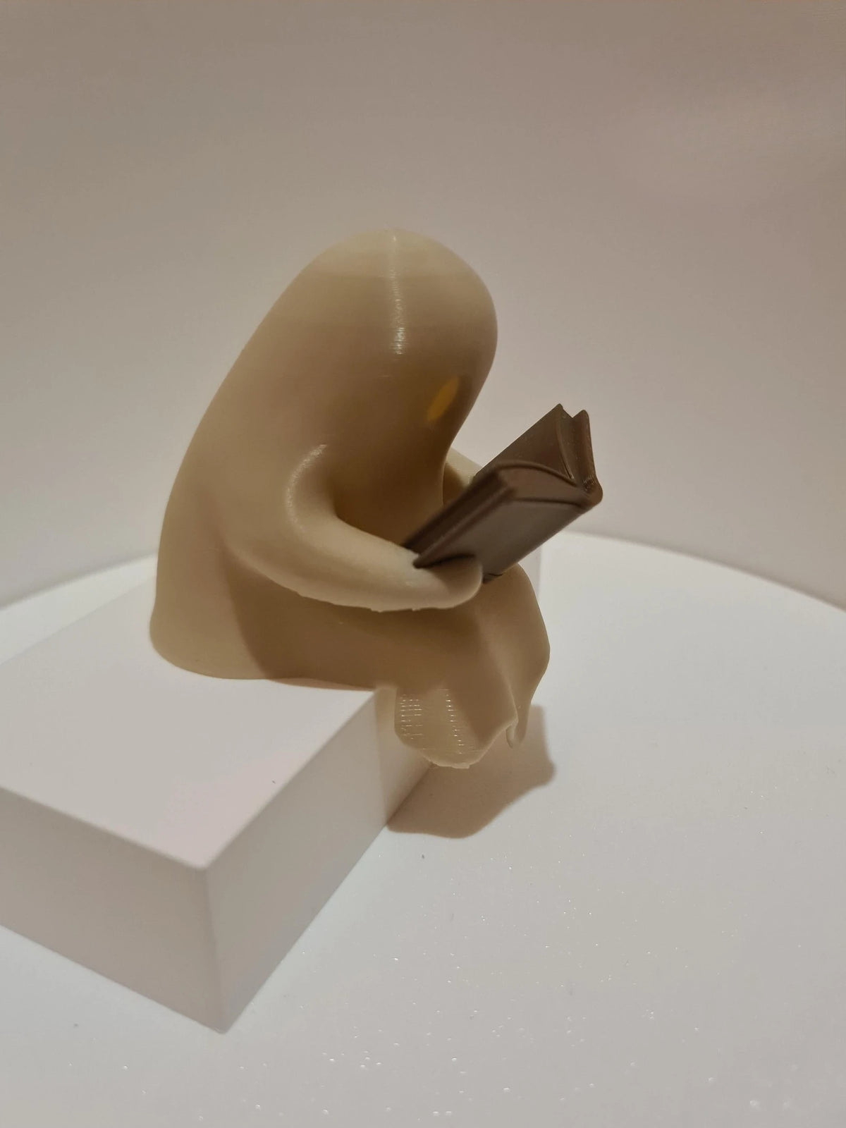 Cute Little Ghost Sitting on A Shelf Reading A Book with Flickering Ornament
