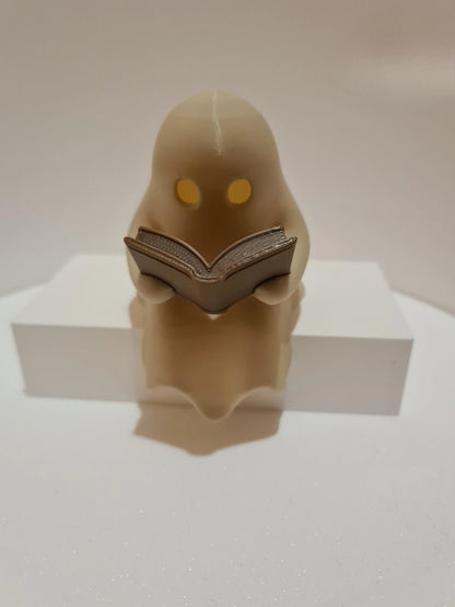 Cute Little Ghost Sitting on A Shelf Reading A Book with Flickering Ornament
